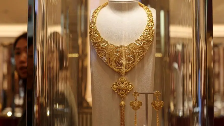 Gold rises on softer dollar, as investors brace for US data