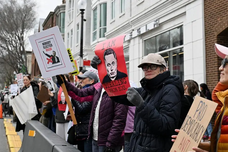 Demonstrators protest against Tesla CEO Elon Musk outside a Tesla dealership in the Georgetown neighborhood of Washington, D.C., U.S., April 12, 2025. REUTERS/Annabelle Gordon. , Reuters