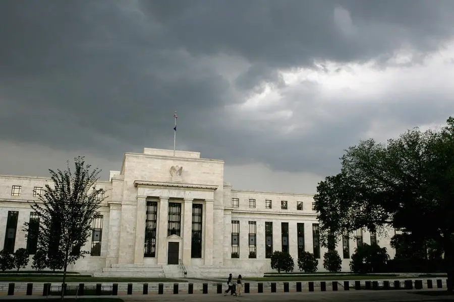 FILE PHOTO: Early summer storm clouds gather over the U.S. Federal Reserve Building before an evening thunderstorm in Washington June 9, 2006. REUTERS/Jim Bourg. , Reuters