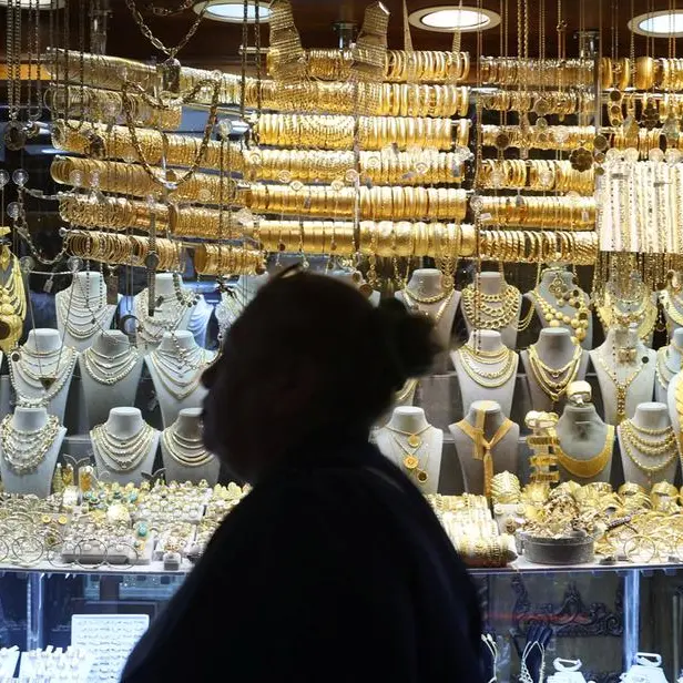 Gold hovers near two-week low as investors book profits