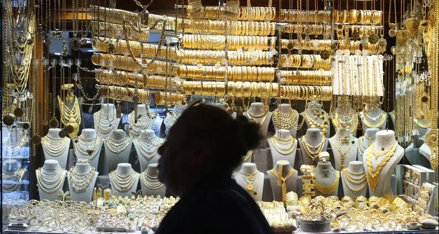 Gold hovers near two-week low as investors book profits