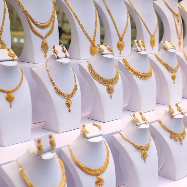 Gold falls 1% on firmer dollar, thin Asia trade