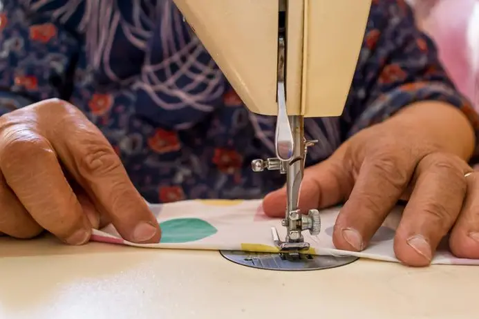 Close up of Old woman hand\\'s using sewing machine, handmade concept, working from home. Image used for illustrative purpose. Image courtesy: Getty Images/ Marwa Elsayed , Getty Images