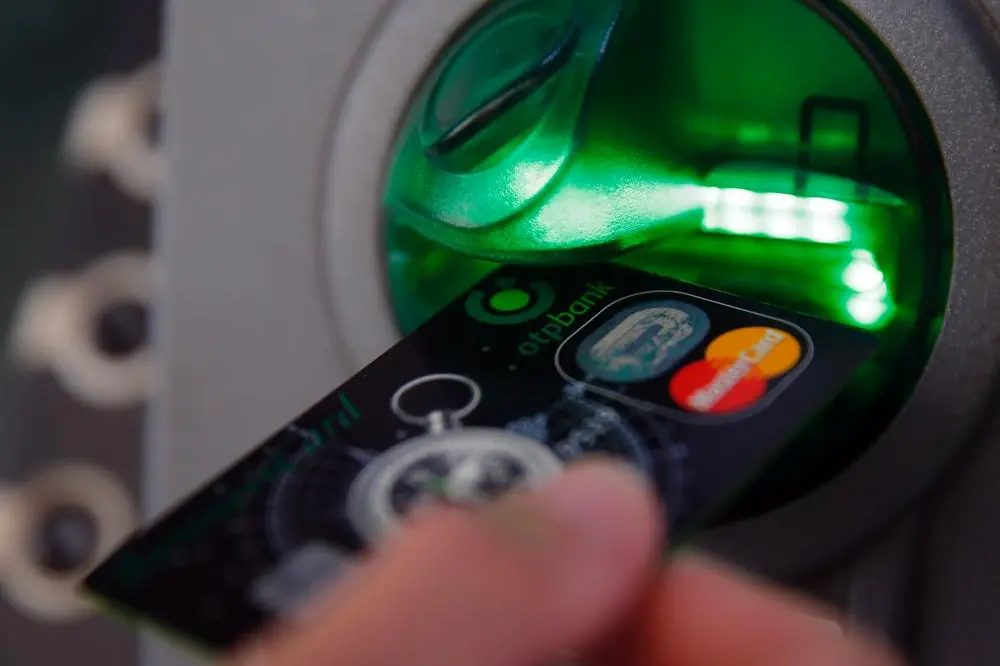 Image used for illustrative purpose. A customer performs a transaction on an ATM. , Reuters Images/Laszlo Balogh