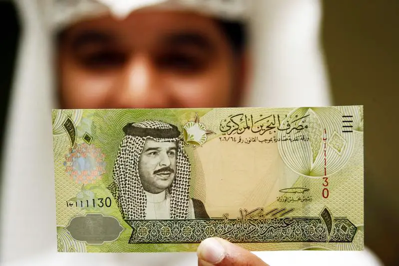 Image for illustrative purposes. Central Bank of Bahrain official shows new BD$10 on first day of its release in Manama.