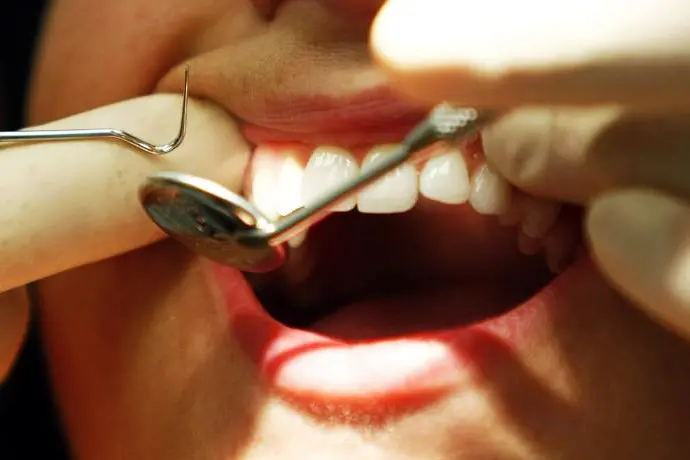 Image used for illustrative purpose.\\r\\n\\r\\nDentist Lance Knight examines a patient for photographers during a photocall to launch the new in store dental service at British supermarket Sainsbury\\'s in Manchester , Reuters Images/Phil Noble
