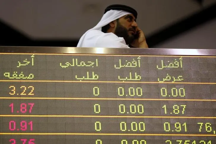 An investor uses his mobile phone at the Dubai Financial Market. , Reuters/Ahmed Jadallah