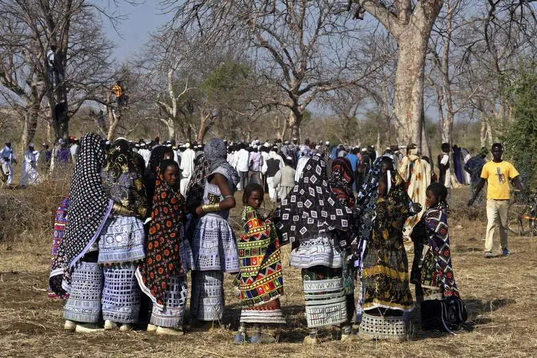 Fulani nomadic tribe members look on during a traditional dance performance in a remote region of Al-Rosaries on the Blue Nile January 6, 2014. In the tribe, men adorn themselves with makeup and trinkets to attract future mates, with tribe members travelling between Sudan, South Sudan and Eritrea seeking pasture for their cattle. Picture taken January 6, 2014.    REUTERS/Stringer , Reuters Images/Stringer