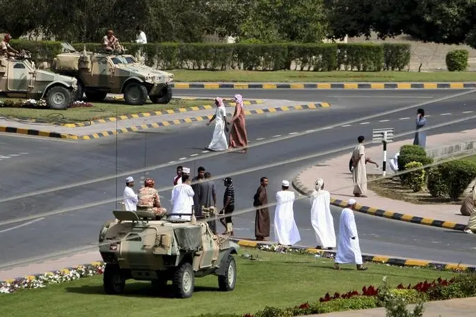 Soldiers keep watch from army armoured vehicles at a roundabout after protesters dispersed in the northern industrial town of Sohar in Oman March 1, 2011. \\r\\nImage used for illustrative purpose. , Reuters Images/Jumana El-Heloueh 