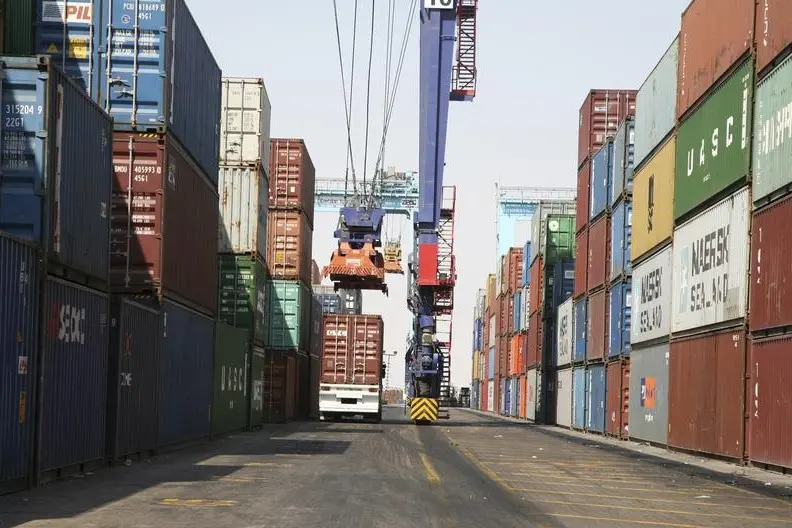 Image used for illustrative purpose. A truck carrying a container drives past stacks of shipping containers at the Port of Aqaba, 350 km (217 miles) south of Amman, September 18, 2011. , Abraham Farajian   