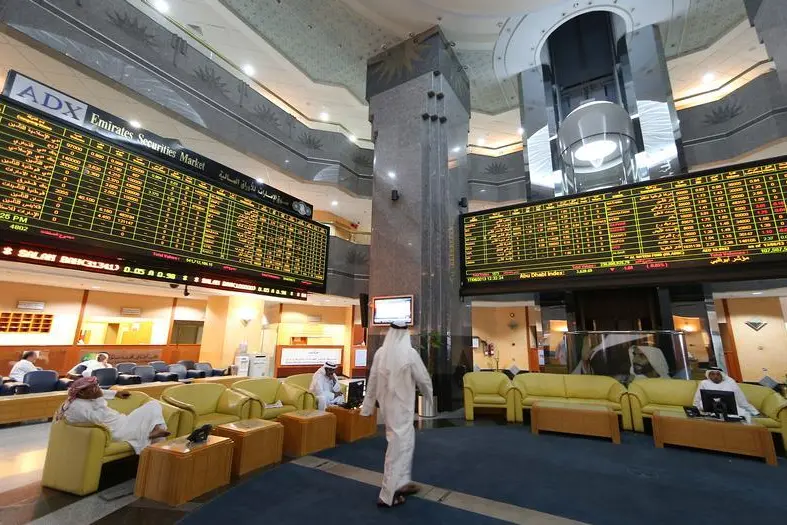 Screens displaying stock information are seen at the Abu Dhabi Securities Exchange, June 17, 2013. , Ben Job 