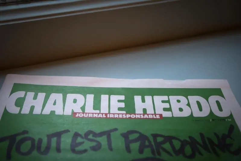 A display copy of the latest issue of satirical French weekly newspaper Charlie Hebdo is pictured at the Albertine bookstore which is part of the French Consulate in Manhattan, New York January 16, 2015. The words read, \"All is forgiven.\"    REUTERS/Carlo Allegri    , Reuters Images/Carlo Allegri   