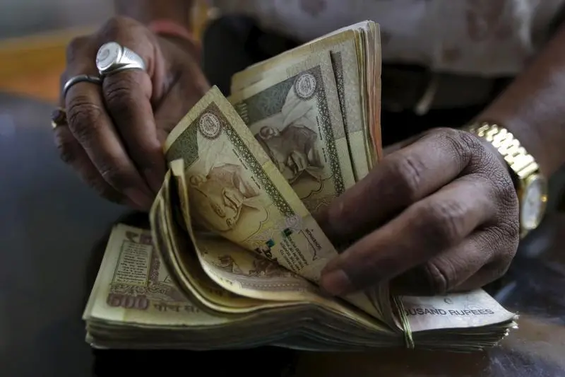 Image used for illustrative purpose. A money lender counts Indian rupee currency notes at his shop in Ahmedabad, India, May 6, 2015. Fresh from his success in securing a mandated inflation target, Reserve Bank of India (RBI) Governor Raghuram Rajan has revived another long dormant reform as he seeks to modernise India\\'s financial architecture: a freely floating currency. Picture taken May 6, 2015. REUTERS/Amit Dave - RTX1C1KG , Amit Dave  - RTX1C1KG