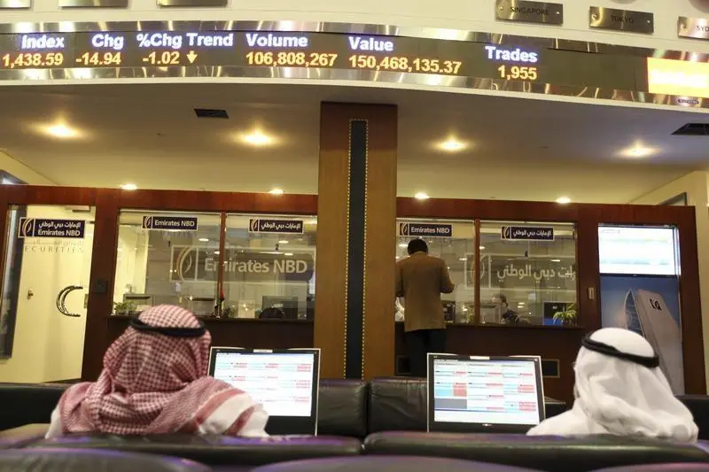 An Emirates NBD counter is seen as traders monitor stocks at the Dubai Financial Market at Dubai World Trade Center, February 2, 2012. Image for illustrative purposes. , Mohamed Al-Sayaghi 