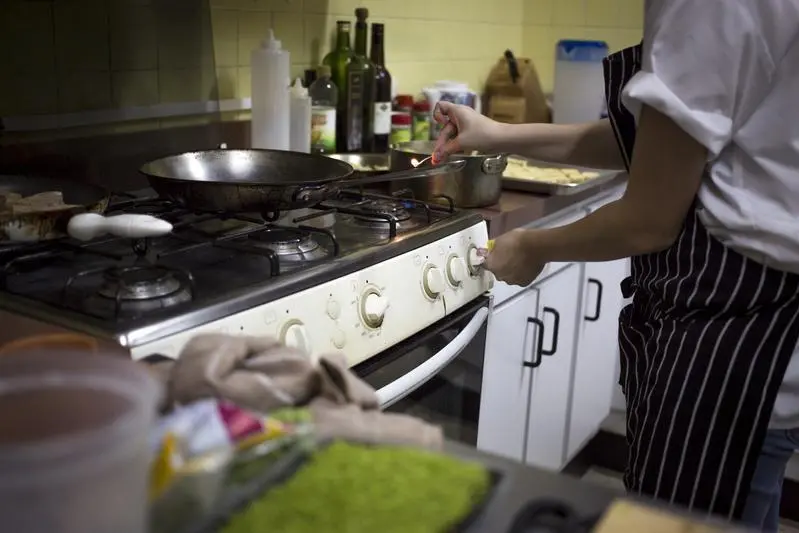 Image for illustrative purpose.\\r\\nHead chef Ana lights the gas stove in the kitchen of the \"Ciboulette Prive\" in Caracas June 9, 2015. As with living-room restaurants that flourished in nineties Havana after the fall of its Soviet benefactor, Caracas is seeing a rise in clandestine dining as inventive restaurateurs seek ways to survive economic crisis, corruption and crime. The elegantly-decorated Ciboulette Prive, which opened in October, serves 16 people under a mango tree with retro artwork on the garden wall and vintage vinyl records as place mats. Picture taken June 9, 2015. REUTERS/Marco Bello  - RTX1G7WL , Reuters Images/Marco Bello  - RTX1G7WL