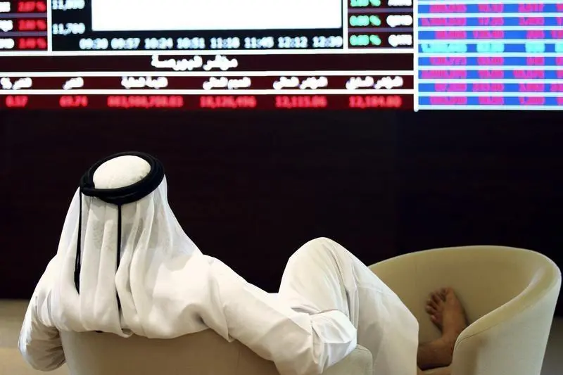 A trader looks at share prices on an electronic display at the Doha Stock Exchange in Doha, Qatar June 3, 2015ened, before cutting its losses to 1.6 percent. Naseem Zeitoon