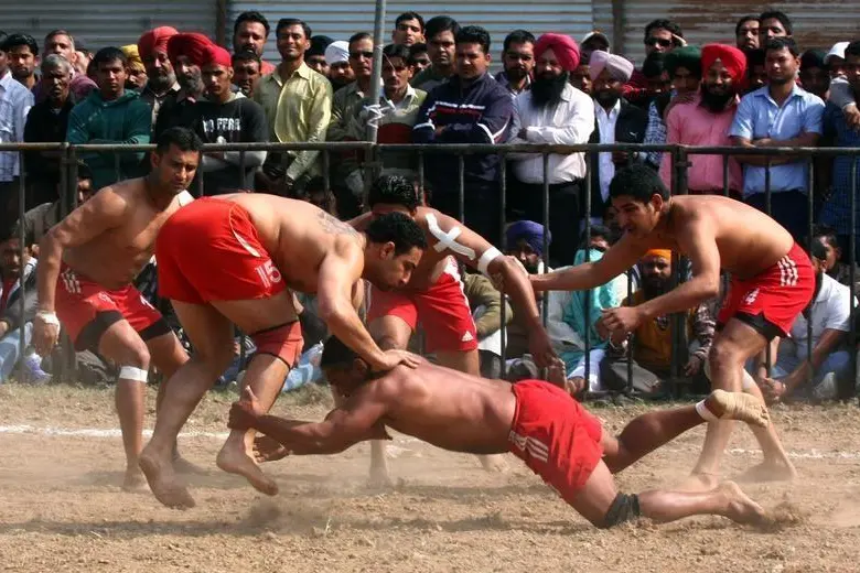 Players from local villages compete in \"Kabbadi\", a traditional game in the northern Indian city of Chandigarh February 21, 2011. In the game of Kabbadi, two teams occupy opposite halves of a field and the objective of the game is to tag as many opposition players as possible in their own territory, all the while repeating the word Kabbadi till the tagging activity is complete. REUTERS/Ajay Verma  , Reuters Images/Ajay Verma 