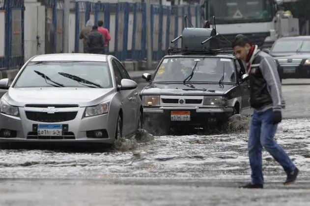 Cars drive through a flooded street after a rainstorm in Cairo December 13, 2013. REUTERS/Mohamed Abd El Ghany  , Reuters Images/Mohamed Abd El Ghany 