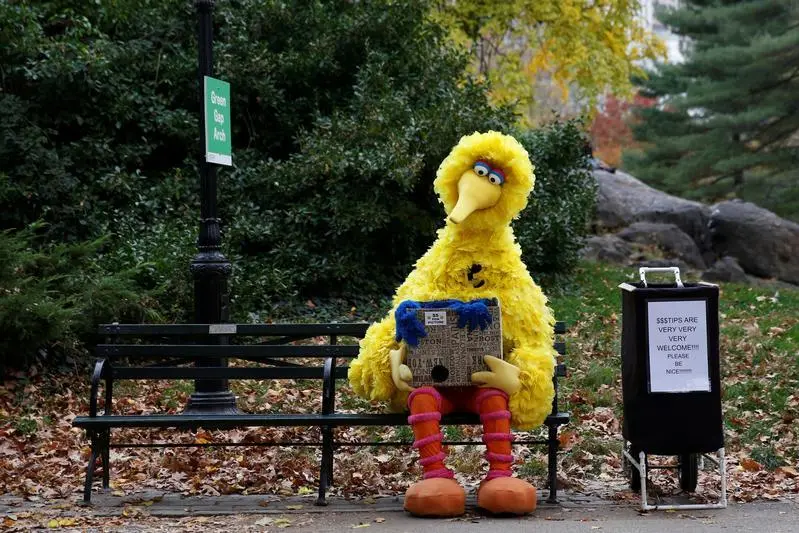 A man dressed as the Sesame Street character Big Bird sits on a bench waiting to take pictures with people walking through Central Park  in New York U.S., November 14, 2016. Image used for illustrative purpose. , Reuters Images/Shannon Stapleton