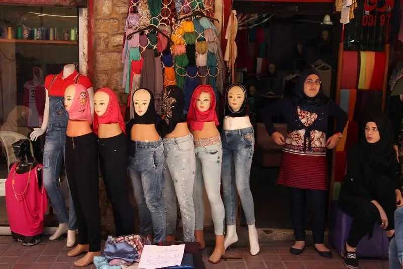 Women stand outside their shop near veils displayed on mannequins for sale during the holy month of Ramadan in Tyre old city, southern Lebanon June 12, 2016. Picture taken June 12, 2016. REUTERS/Alia Haju \\r\\nimage used for illustrative purpose , Reuters Images/Alia Haju 