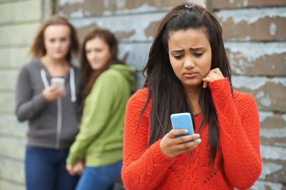 Teenage girl being bullied by text message. Image used for illustrative purpose