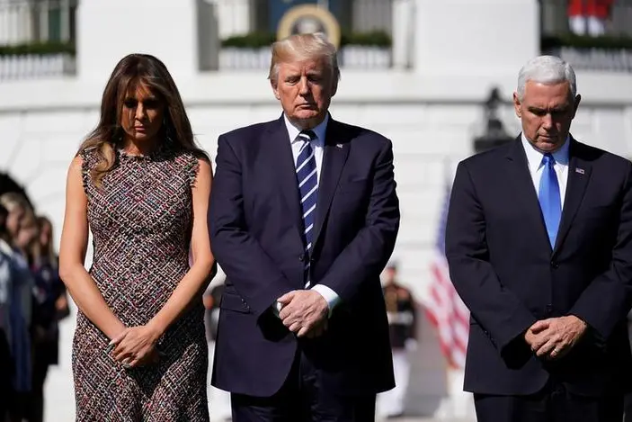 U.S. President Donald Trump stands with first lady Melania Trump and Vice President Mike Pence during a moment of silence in the wake of the the mass shooting in Las Vegas at the White House in Washington, U.S., October 2, 2017.   , Reuters Images/Joshua Roberts
