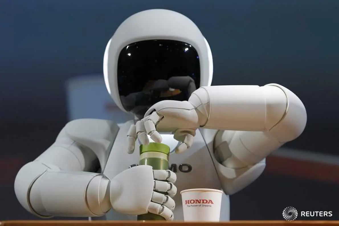 Image used for illustrative purpose. Honda Motor Co\\'s Asimo humanoid robot opens the top of a bottle to pour the drink into a cup during a news conference at the 42nd Tokyo Motor Show in Tokyo November 30, 2011.   , Reuters Images/Toru Hanai 