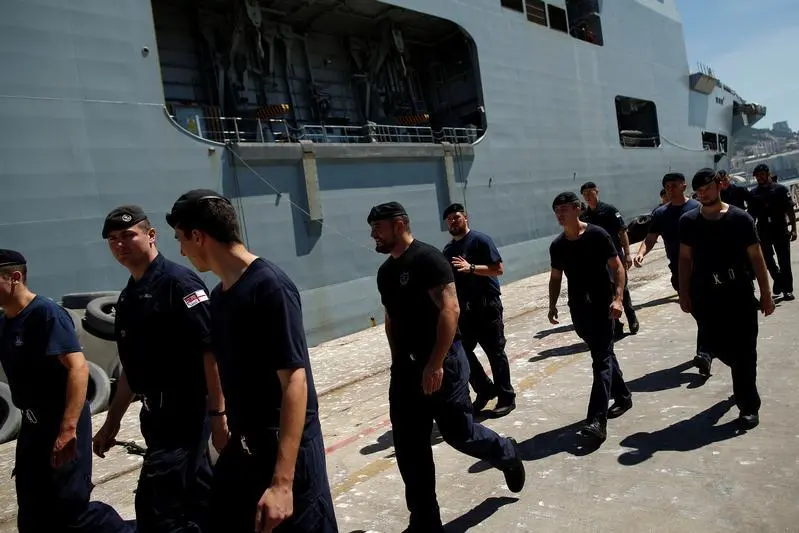 image used for illustrative purposes.\\r\\nCrew walk as they embark supplies in the Royal Navy helicopter carrier HMS Ocean before crossing the Atlantic to provide humanitarian assistance and vital aid to British Overseas Territories and Commonwealth partners affected by Hurricane Irma, at the naval base in the British overseas territory of Gibraltar, historically claimed by Spain, September 11, 2017.  , Reuters Images/Jon Nazca 