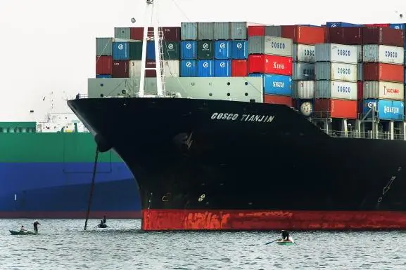Egyptian fisherman work their nets near international cargo container ships anchored in the Suez canal in Ismailia, Egypt December 14, 2004.Image used for illustrative purposes. Getty Images/Scott Nelson