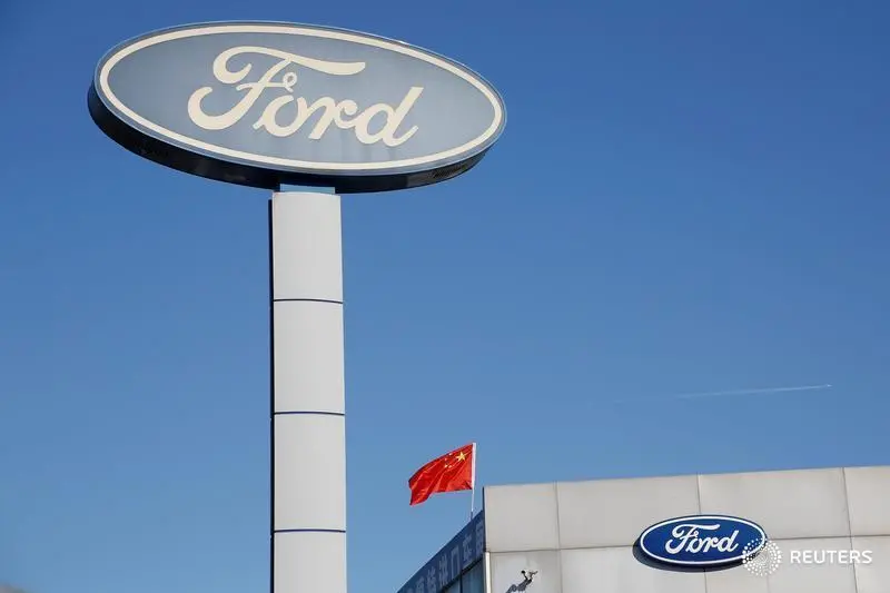 The Chinese national flag flies on the roof of a Ford car dealership in Beijing, China October 11, 2018. To match Exclusive CHINA-AUTOS/DEALERS. REUTERS/Thomas Peter - RC14A6827DF0 , Thomas Peter - RC14A6827DF0