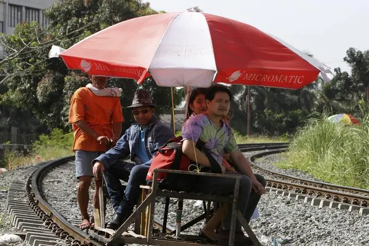 A wooden makeshift trolley carrying passengers moves along a railway line in Manila March 5, 2012. The makeshift trolley, which does not run on fuel, is one of the cheapest form of transportation in the capital as local petroleum prices continue to rise with world market prices. The trolley carries up to eight passengers for a 2 km (1.2 miles) journey and costs 10 pesos ($0.23) per passenger.  , Reuters Images/Romeo Ranoco 