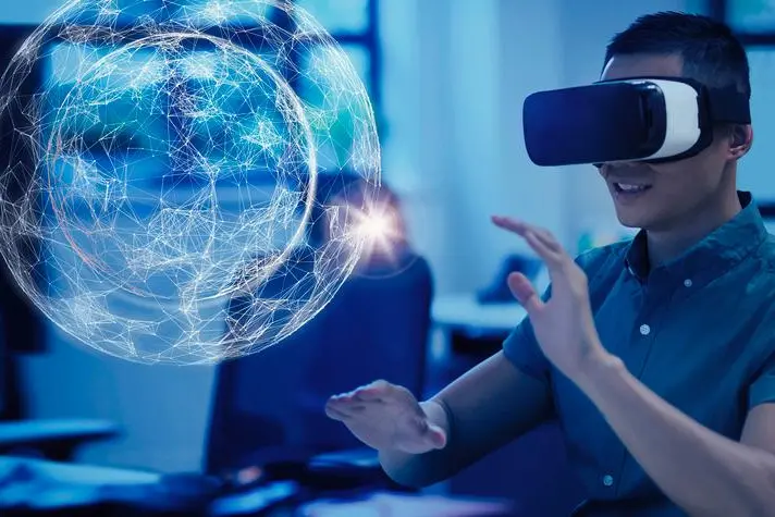Image used for illustrative purpose.\\r\\nComputer programmer testing virtual reality simulator glasses, viewing projection hologram , Getty Images