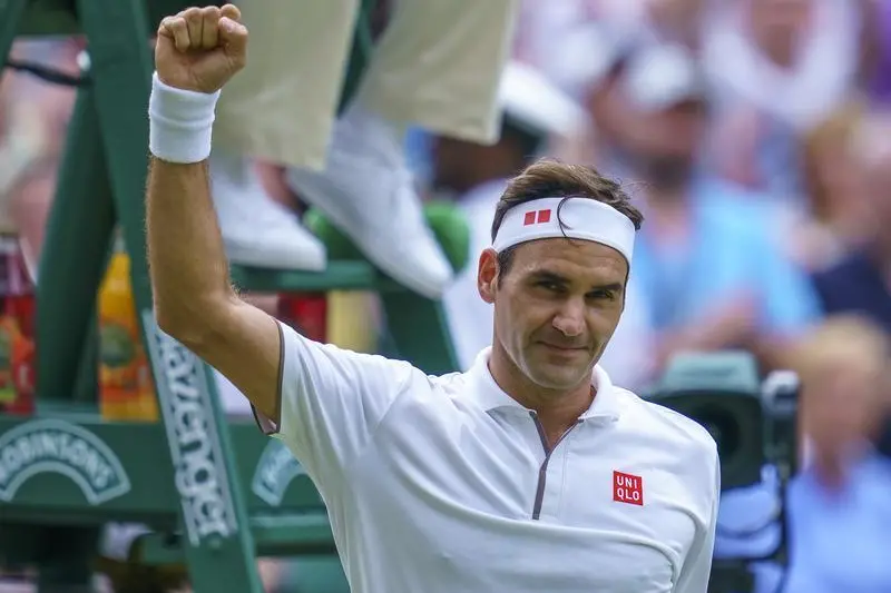 London, United Kingdom; Roger Federer (SUI) celebrates after match point during a match against Lucas Pouille (FRA) on day six at the All England Lawn and Croquet Club. Mandatory Credit: Susan Mullane-USA TODAY Sports