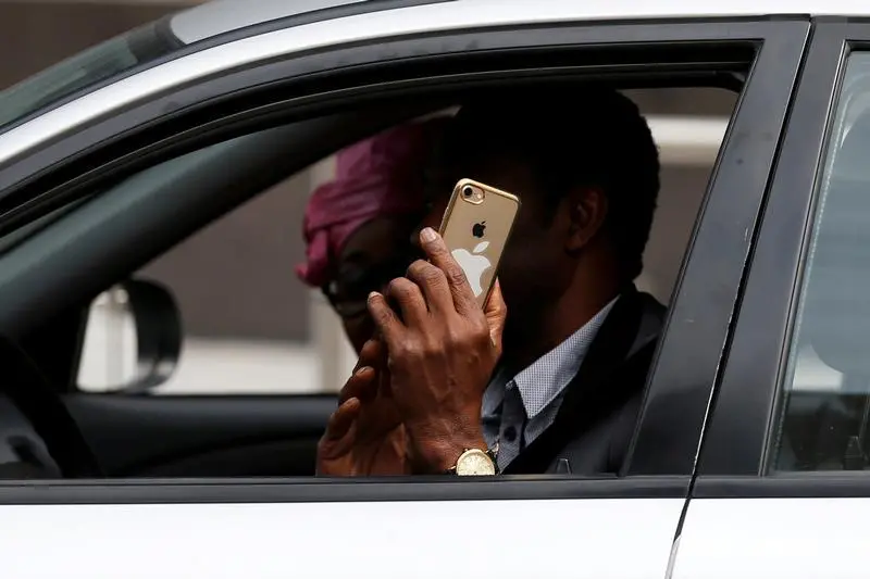 Image used for illustrative purpose.\\r\\nA man uses his mobile phone as he drives his car in central Brussels, Belgium, July 3, 2017.   , Reuters Images/Francois Lenoir 