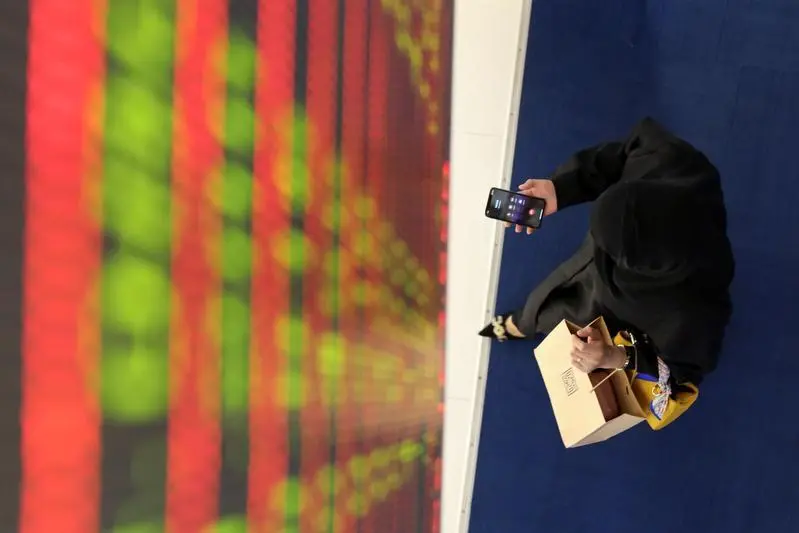 A woman uses her mobile at Dubai Financial Market in Dubai, United Arab Emirates September 16, 2019. , Christopher Pike 