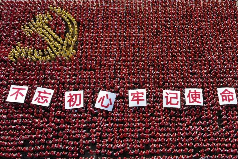 Chinese Communist Party (CPC) members arrange to form into a shape of a Chinese Communist Party\\'s flag, with cardboards reading \"Remain true to our original aspiration and keep our mission firmly in mind\" during an event celebrating Chinese Communist Party\\'s founding 98th anniversary, in Jinhua, Zhejiang province, China June 28, 2019. Picture taken June 28, 2019. REUTERS/Stringer ATTENTION EDITORS - THIS IMAGE WAS PROVIDED BY A THIRD PARTY. CHINA OUT. - RC1BB3AFD9B0