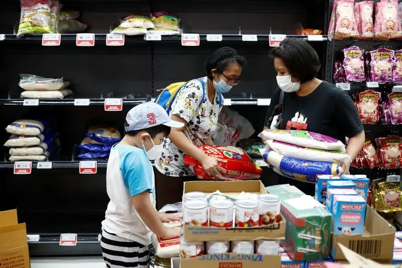 People stock up on rice after Singapore raised the coronavirus outbreak alert level to orange, at a supermarket in Singapore February 8, 2020. , Reuters Images/Edgar Su 