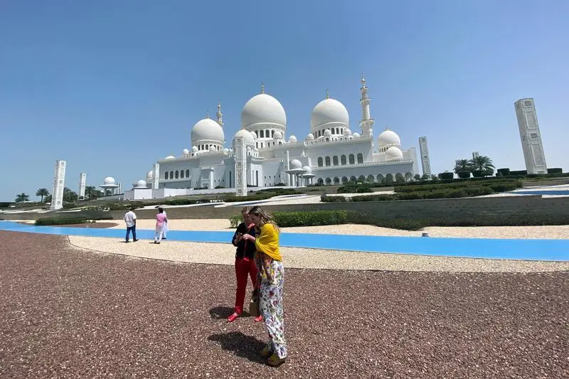 Tourists are seen outside empty Sheikh Zayed Mosque, as Friday prayers were suspended following the spread of the coronavirus disease (COVID-19), in Abu Dhabi, United Arab Emirates, March 20, 2020.  , Reuters Images/Satish Kumar 