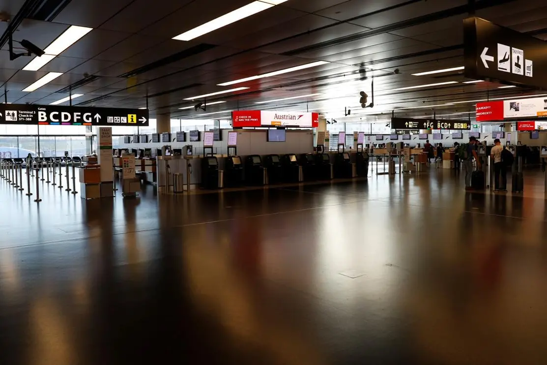 Empty Austrian Airlines check-in counters are seen during the spread of the coronavirus disease (COVID-19) at Vienna\\'s airport in Schwechat, Austria March 18, 2020. REUTERS/Leonhard Foeger