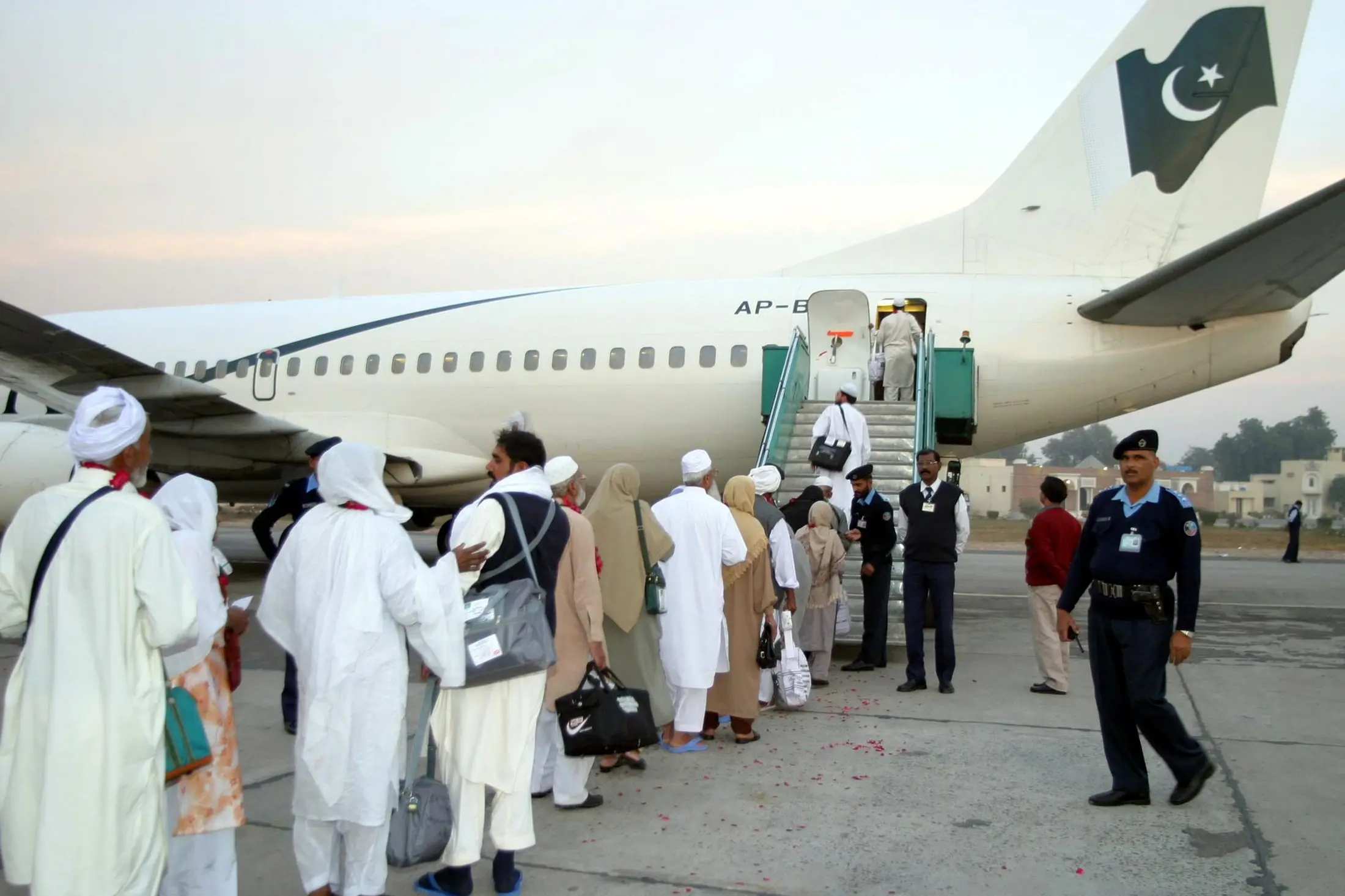 Pakistani Muslim pilgrims walk towards a plane bound for Saudi Arabia to perform the annual Hajj pilgrimage at Multan.  , Reuters Images/Asim Tanveer