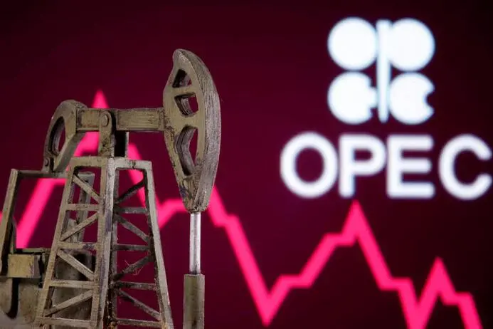 A 3D printed oil pump jack is seen in front of displayed stock graph and Opec logo in this illustration picture, April 14, 2020. , Reuters/Dado Ruvic/Illustration