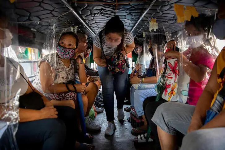 A passenger wearing a protective mask enters a jeepney with makeshift plastic barriers to maintain social distancing amid the coronavirus disease (COVID-19) outbreak, in Angono, Rizal province, Philippines, June 3, 2020. , Reuters Images/Eloisa Lopez