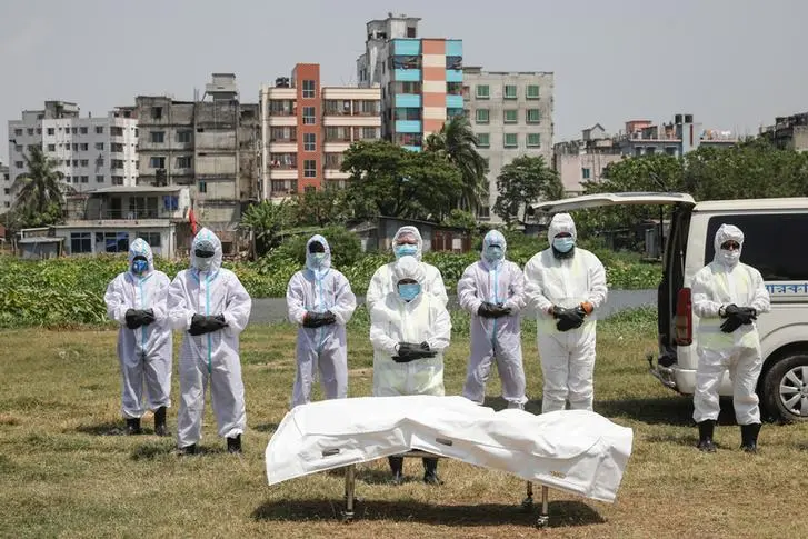 People, wearing protective suits, offer funeral prayers for a man who died due to coronavirus disease (COVID-19), before his burial at a graveyard in Dhaka, Bangladesh, April 6, 2020. \\r\\nImage used for illustrative purpose. , Reuters Images/Mohammad Ponir Hossain