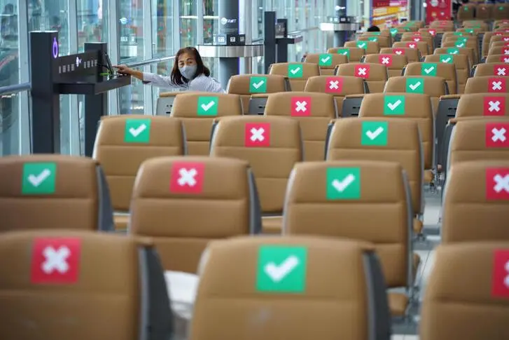 A tourist wearing a protective mask sits on a social distancing seat as she waits for her flight at Bangkok\\'s Suvarnabhumi International airport amid the spread of the coronavirus disease (COVID-19), Thailand, June 3, 2020.  , Reuters Images/Athit Perawongmetha