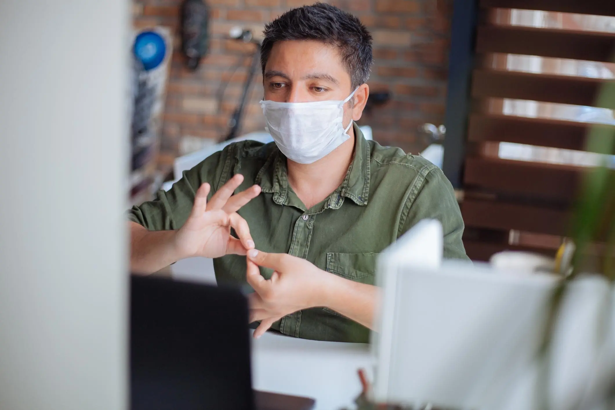 Deaf man using sign language while video chatting,\\r\\nImage used for illustrative purpose. , Getty Images