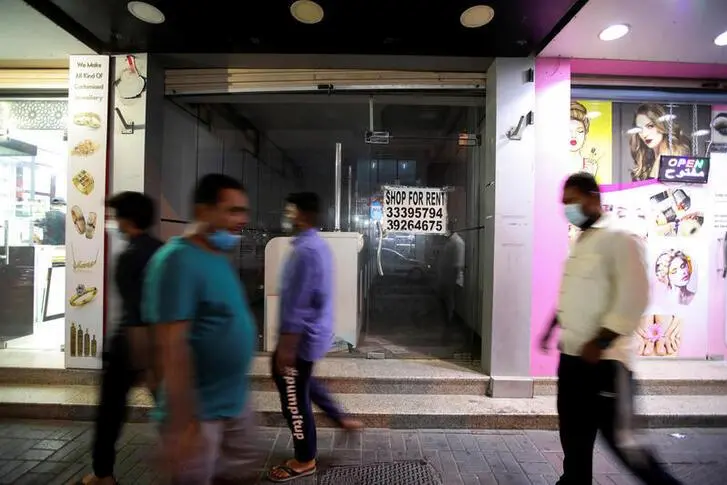 Men wearing face masks pass in front of an empty shop with a \"Shop For Rent\" signage displayed on its window, following the outbreak of the coronavirus disease (COVID-19), in Manama, Bahrain, October 6, 2020. , Reuters Images/Hamad I Mohammed