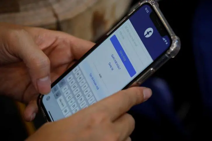 A Facebook user logs in on his mobile at a cafe in Hanoi, Vietnam November 19, 2020.  , Reuters Images/Kham