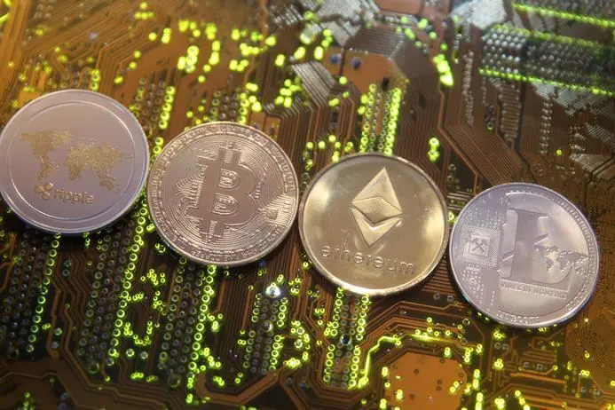 Representations of the Ripple, Bitcoin, Etherum and Litecoin virtual currencies are seen on a PC motherboard in this illustration picture, February 13, 2018.Dado Ruvic/Illustration REUTERS