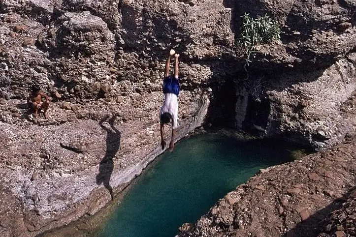 Temperatures soaring around 45 centigrade prompt United Arab Emirates youth to jump into Hatta mountain water in Dubai, June 20,2004.\\r\\nImage used for illustrative purpose. , Reuters Images/Anwar Mirza 
