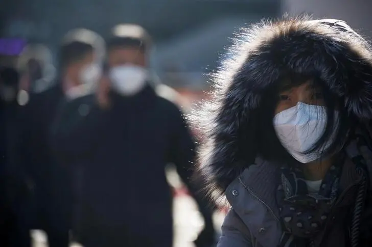 People wait in a line to undergo coronavirus disease (COVID-19) test at a coronavirus testing site which is temporarily set up in front of a railway station on Christmas day in Seoul, South Korea, December 25, 2020.   , Reuters Images/Kim Hong-Ji